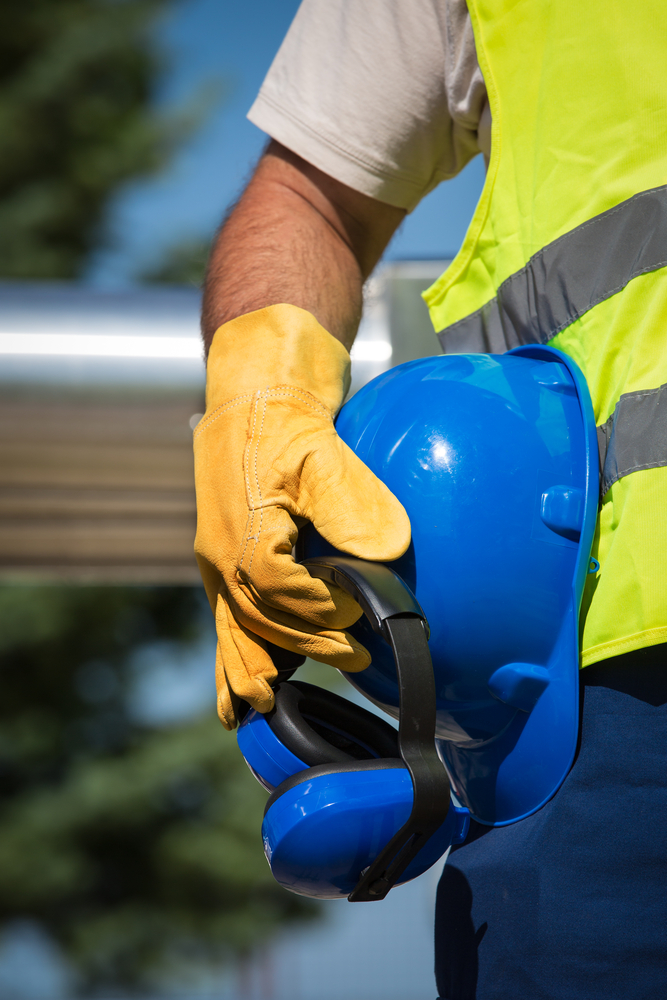 image showing a man holding a hard hat